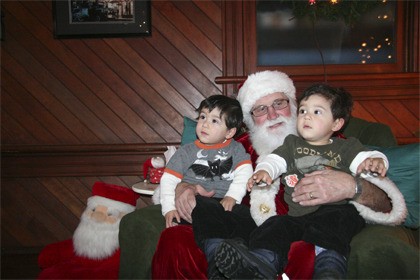 Felix and Hugo Horn snuggle close to Santa at the Northwest Railway Museum in Snoqualmie