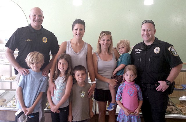 Sharing 'Coffee and Doughnuts with a Cop' on June 26 were a group of youngsters and their parents. Pictured from left: front row