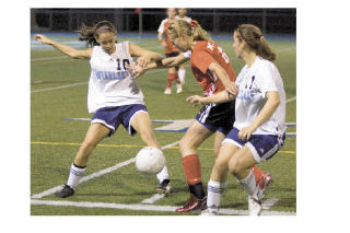 Mount Si’s Alexis Pearlstein battles for the ball against two Interlake defenders during last Thursday’s away match. The Wildcats maintained possession for much of the 3-0 win.