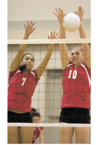 Mount Si players Mackenzie Peerboom and Robyn Schirmer block a ball at the net during Monday’s game against Mercer Island.