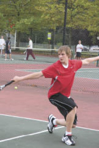 Brian Johnson returns a serve from Mercer Island players during doubles at home last Thursday.