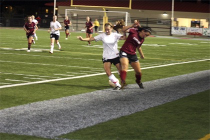 Mount Si right back Ashley Davis jostles with an Eastlake player