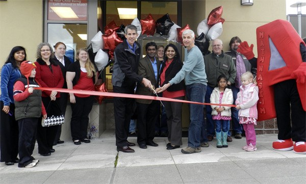 Members of the Snoqualmie Valley Chamber of Commerce gather to cut the ribbon Jan. 28 for the new  Snoqualmie Ridge Mathnasium.