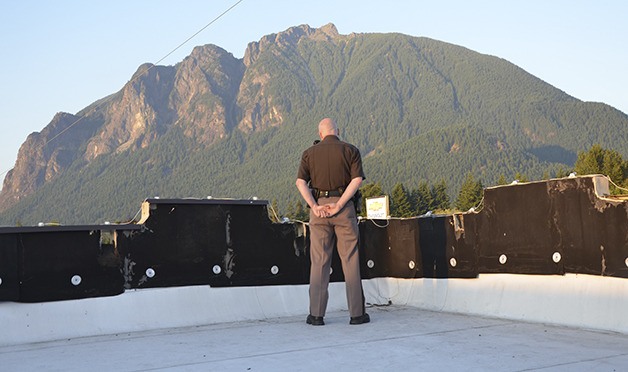 Former North Bend Police Chief Mark Toner looks over the parapet at Boxley’s during the 2013 North Bend Block Party. He was voted best police officer in the Best of the Valley poll.