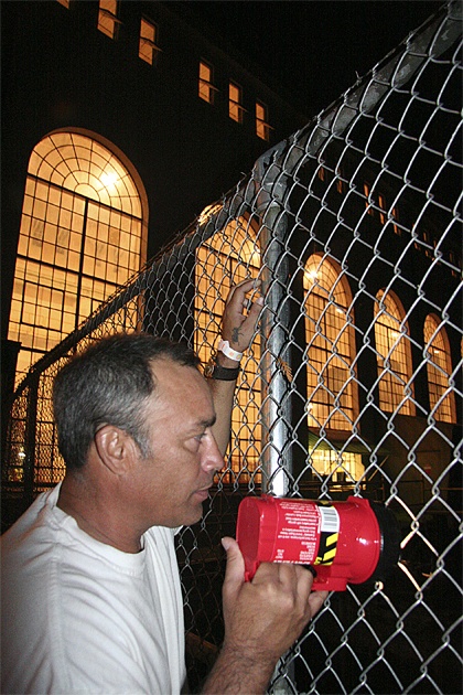 Ken Senteno of North Bend uses his flashlight to check out the water outflow of the Cedar Falls power station. The tall windows of the plant light up the night behind him. “It’s beautiful