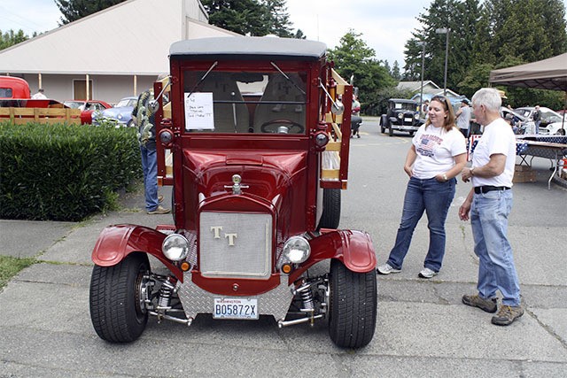 Car fans discuss a classic at the 2013 car show. This year’s show will be at Tolt-MacDonald Park