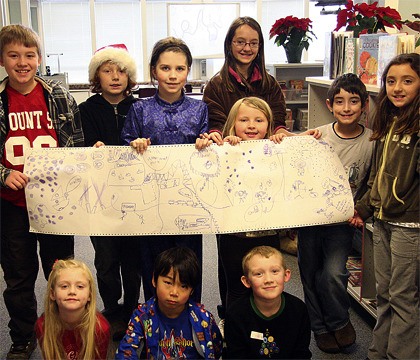 Students in the Fall City Families program create a story banner as part of a group activity. Pictured are