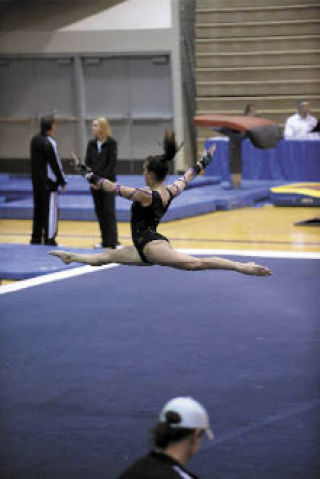 Gymnast Cami Guyer performs on the floor during state finals in Seattle.