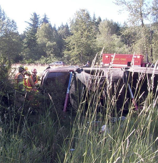 Eastside Fire and Rescue crews prop up a Ford pickup following a rollover accident Thursday morning