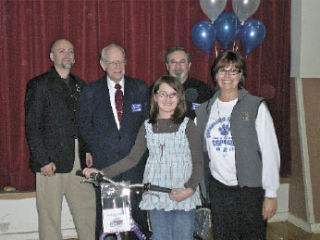 Student Rachel Hunter stands with her new bike