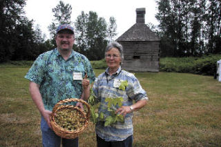 Clint Whitaker and Ruth Pickering share samples of hops and vines at the Fall City Hop Shed. For more Fall City Days coverage