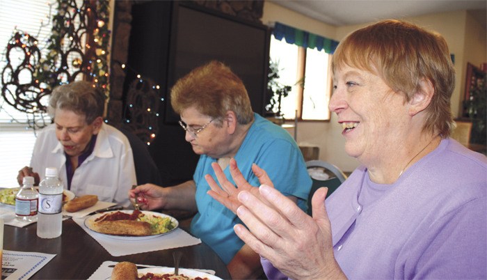 Smiling and gesturing during lunch with members