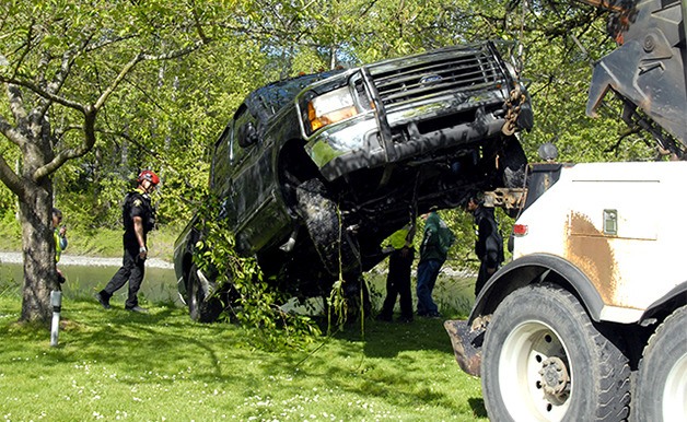 A blue-green Ford F150 pickup