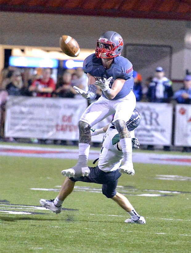 Caleb Mitchell jumps up to catch a pass from JoJo Hillel in the third quarter of Mount Si's home match with Skyline. The Spartans grabbed an early lead to win 49-27.