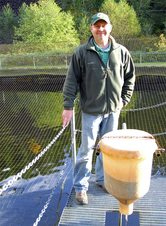 Tokul Creek Hatchery Manager Darin Combs stands over the hatchery’s big pond