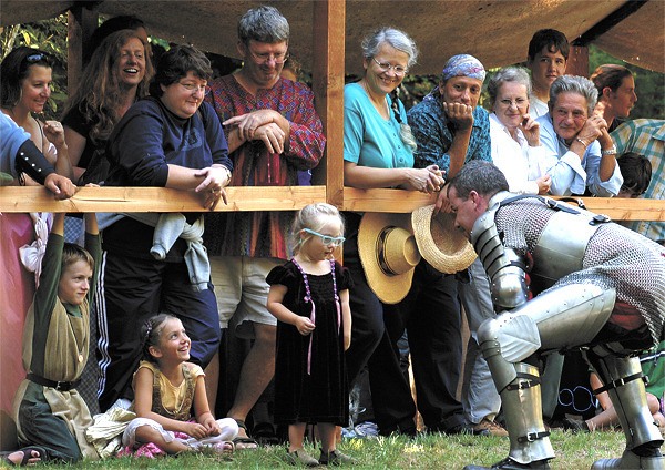 An armored re-enactor visits with the audience at Camlann.