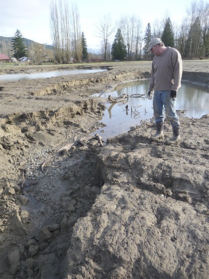 Fall City Farms owner Rob Arenth surveys what visitors dubbed the farm’s “new grand canyon