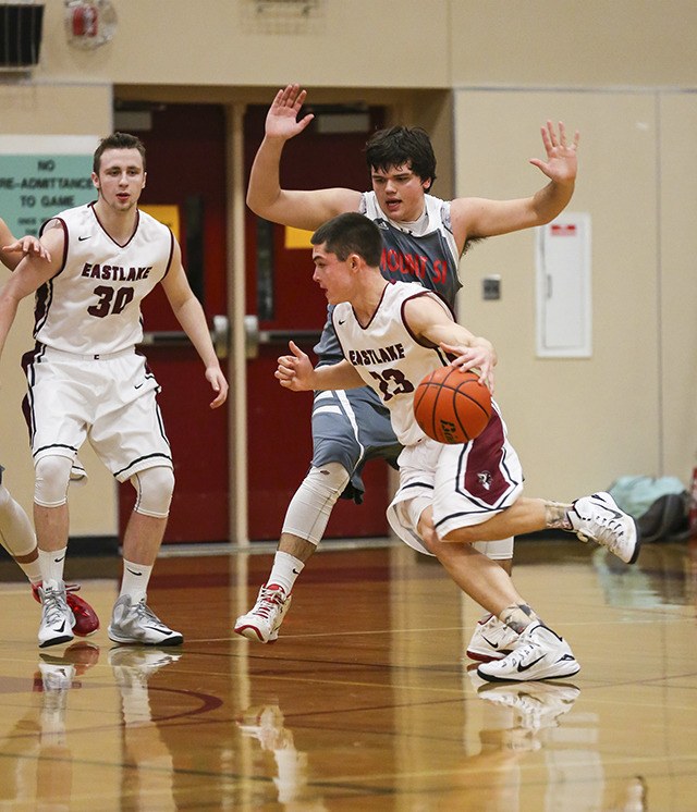 Mount Si’s Matt Myers tightly guards Eastlake Wolves senior guard Jordan Lester as he drives to the basket in a conference game on Friday