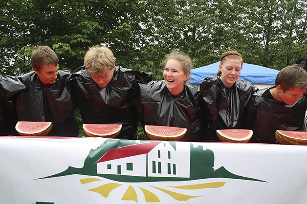 Trash-bag-wearing contestants line up for the 2014 watermelon-eating contest at Fall City Day.