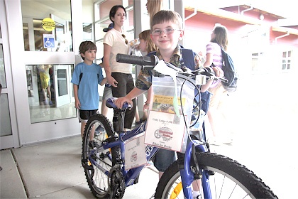 Cascade View Elementary Studenty Ryan Turner shows off his new bike