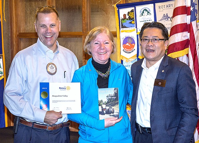 Snoqualmie Valley Rotary President Dan Marcinko accepts a certificate of appreciation from Lynda Lahman and Son Michael Pham.