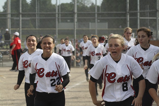 Mount Si's fastpitch team hustles off the field following their round 2 win Wednesday at SeaKing Districts. The Wildcats go to state next weekend