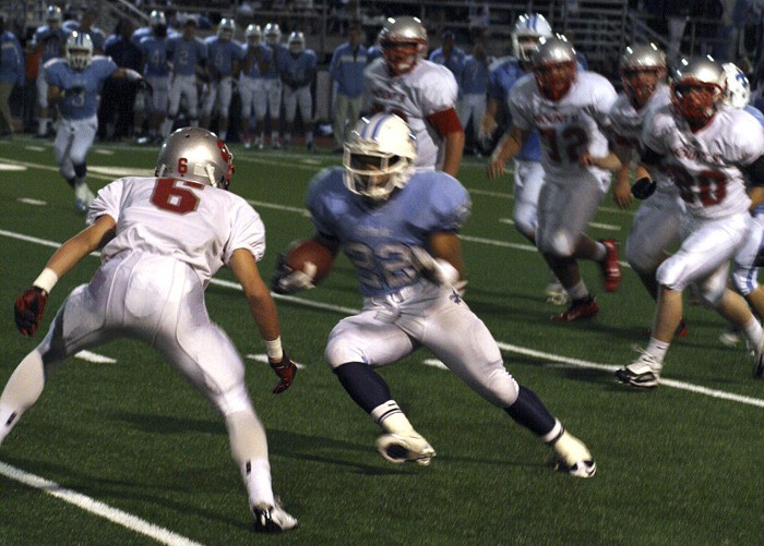 Mount Si's Jimbo Davis gets in the path of Interlake carrier Jordan Todd as the Wildcat defense close in from the sides.