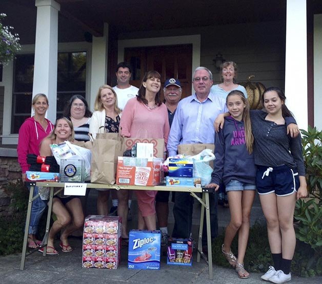 Mount Si Lions and Leo Club members gather with the items they helped collect this summer for Friends of Youth in the Valley and YouthCare.