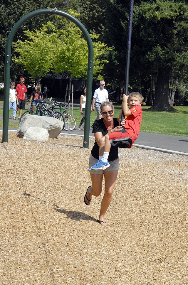 A mom gives her son a push on the zipline at Si View Park.