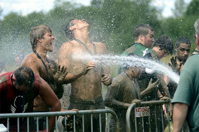 Runners clean up in a blast of water during the Warrior Dash