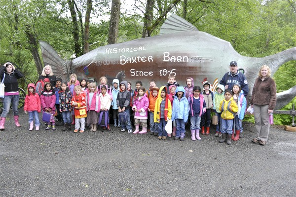 Schoolchildren visit a newly decorated Bubbles the Salmon sculpture at Fall City's Baxter Barn. The artistic Fall City Days float got a farm makeover for the 40th festival.