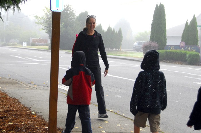 Kindergarten teacher Vanessa Hair walks backward to watch her students on the mile-long evacuation drill hike from Carnation Elementary School to Tolt Highlands Road.