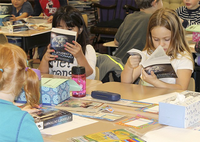 Students quickly dig into their new dictionaries