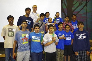 Chief Kanim Middle School science teacher Todd Henderson congratulates the winners of the You Be the Chemist Challenge