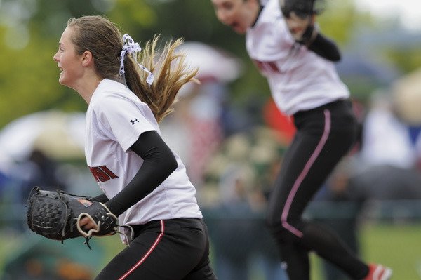 Tamarra Crowe and Maura Murphy react to an extra innings win over Wilson during state tournament play at the Regional Athletic Complex in Lacey on Friday