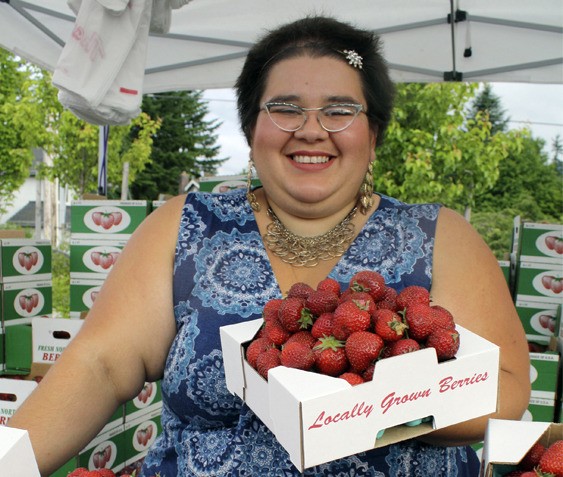 Alexandria Vizcaya of Jessie’s Berries offers strawberries at opening day of the North Bend Farmer’s Market. She plans to offer produce all summer long at Si View Park.