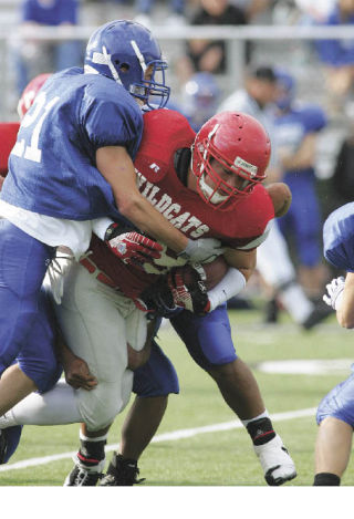 Alex Heibert busts through a Bothell tackle during Saturday’s scrimmage match at Mount Si High School. The Wildcats are showing promise for a good season in the fall.