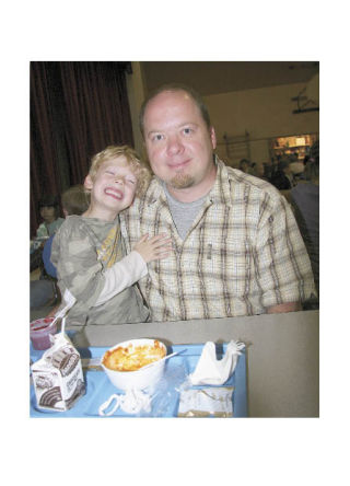 Kindergartner Matthew Conklin enjoys lunch with his dad