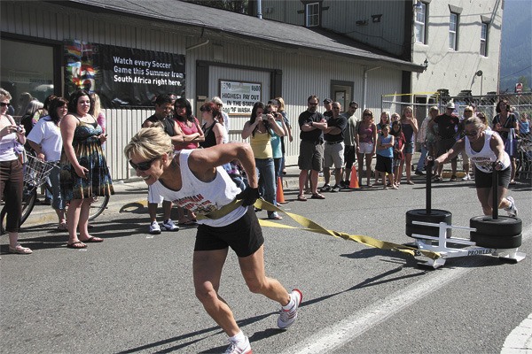 Competitors hustle heavy cargo during the Almost Strongest Man (and woman) event at North Bend's downtown block party.