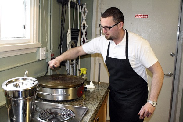 Sinacia Yovanovich readies the crepe griddle for the day with a few scrapes of the spatula in his immaculate kitchen at the Eurolounge Cafe