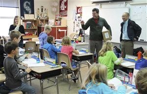 Kiwanis members Joe Larson and Carlos De Imus take questions from a classroom when they visited Cascade View Elementary School to hand out new dictionaries to every third grader.