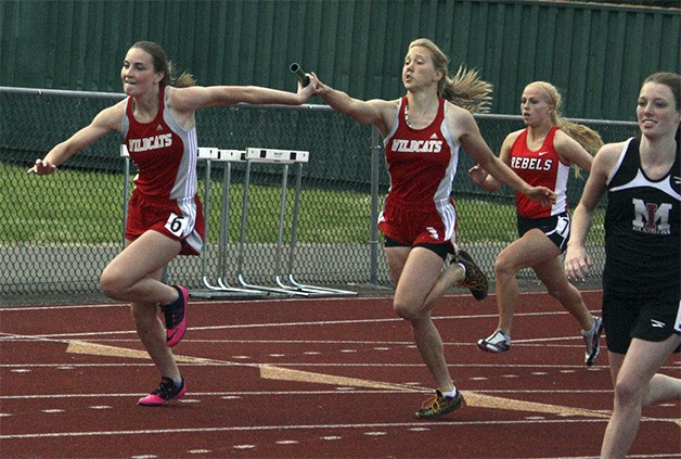 Sydney Leonard hands off to Lauren Rutherford in the final leg of the girls 4x100 relay