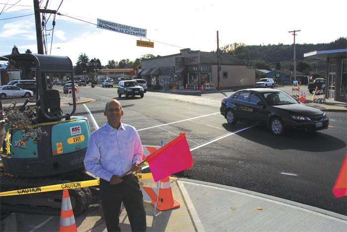 Carnation Councilman Stuart Lisk holds one of the flags that city residents have used to cross Tolt Avenue