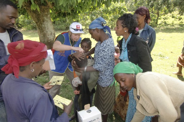 Administering an oral polio vaccine to a child