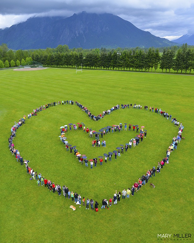 A double symbol of love forms in the 2013 “Heart of the Valley” community photo shoot at Snoqualmie’s Centennial Fields. Organizer Mary Miller plans surprise shapes for this year.