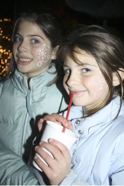 Sisters Morgan and Meghan Pettersson-Feret get flake facepaint at the Fall City holiday tree lighting and all-town party