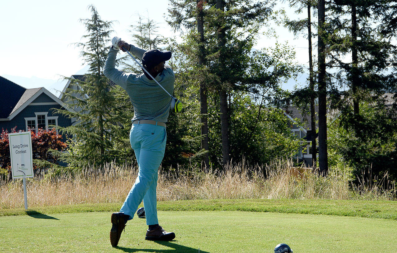 Jordan Babineaux tries for the longest drive Monday morning at the start of the Boeing Classic.                                (Carol Ladwig/Staff Photo)