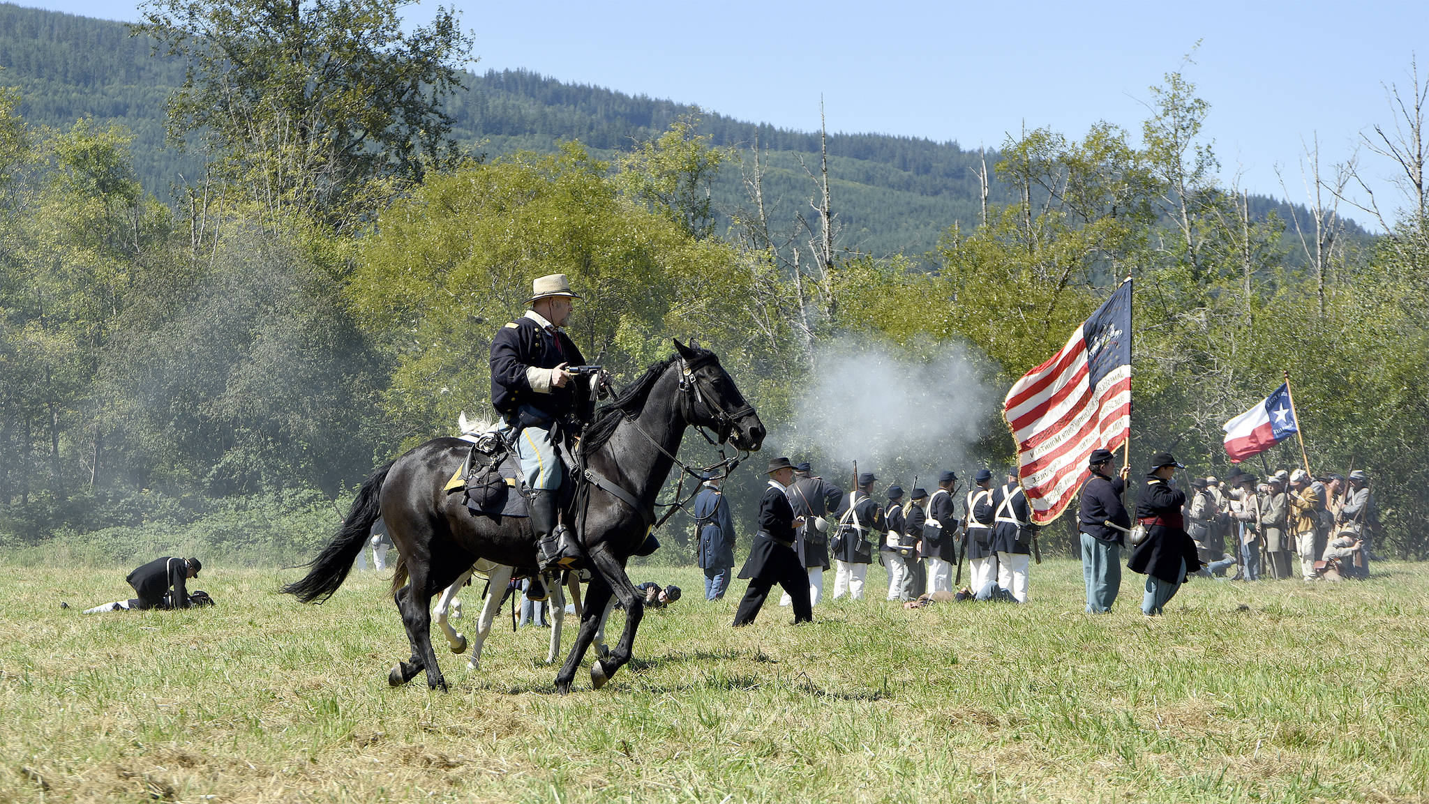 A Union cavalry man follows the foot soldiers into battle last year as re-enactors demonstrated a Civil War-era clash on Meadowbrook Farm.