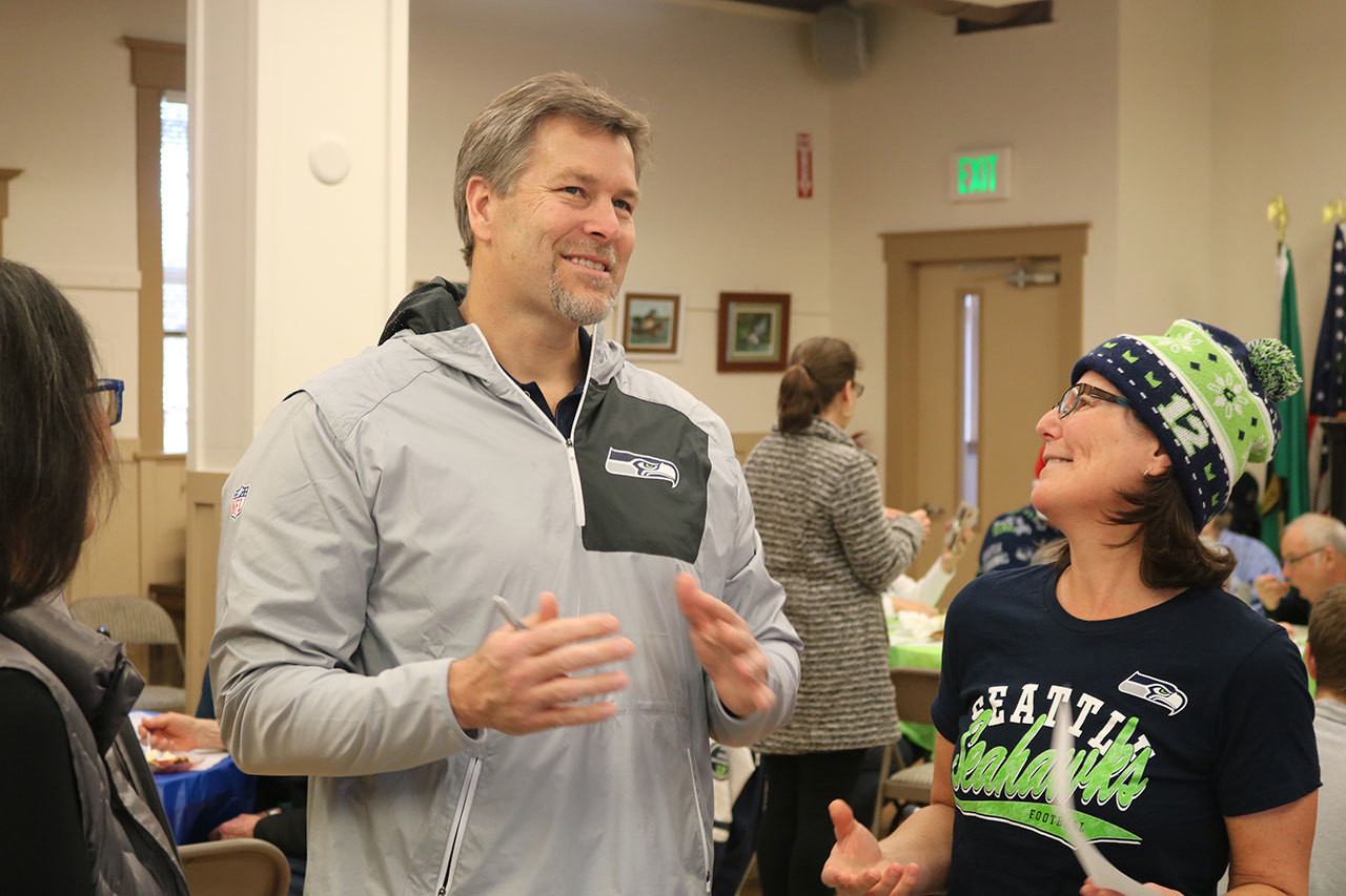 Robbie Tobeck talks to some of the fans and signs autographs at the 2016 12 Days of Goodnewss holiday lunch at Sno-Valley Senior Center in Carnation. (Evan Pappas/Staff Photo)