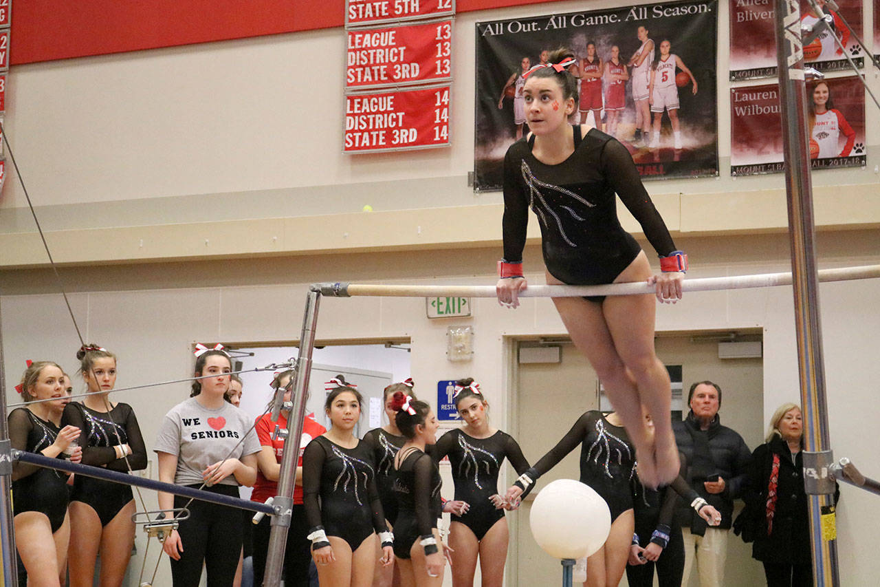 Gabrielle Recchi begins her bars routine at Mount Si’s match against Eastlake on senior night, Jan. 18. (Evan Pappas/Staff Photo)